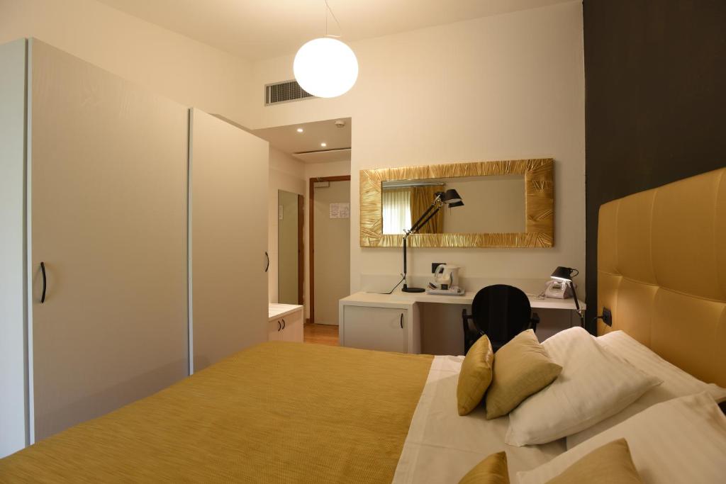 Posteľ alebo postele v izbe v ubytovaní Hotel La Vigna