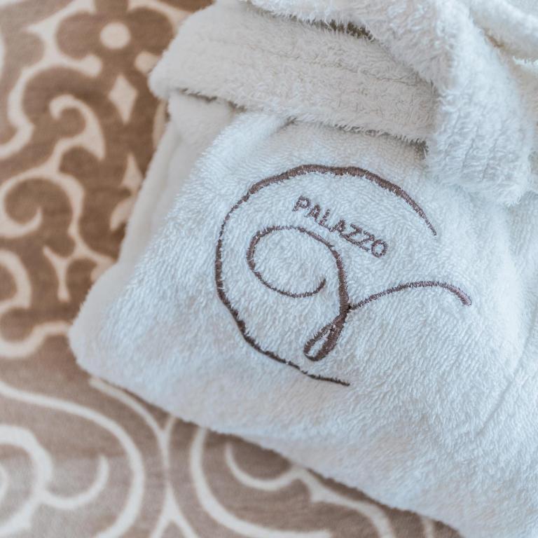 a towel with the word pizza written on it at Palazzo Violetta in Sliema