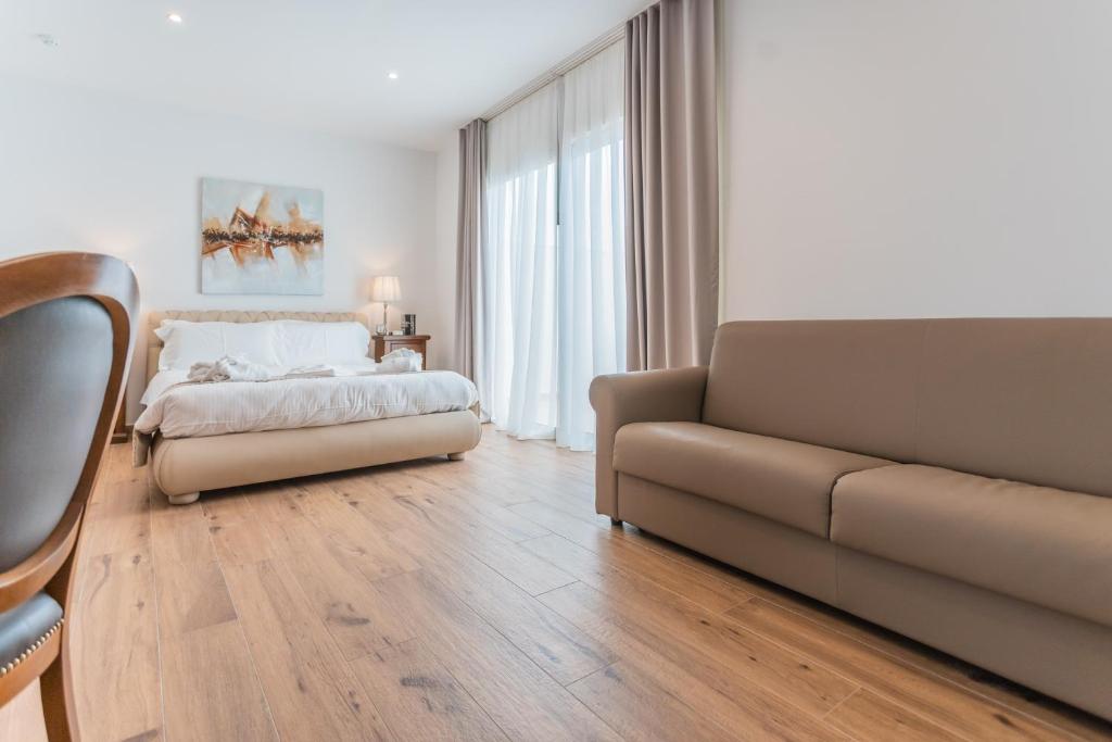 a living room with a bed and a couch at Palazzo Violetta in Sliema