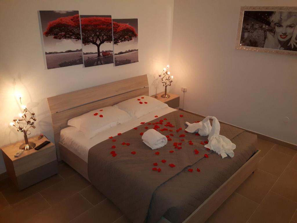 een slaapkamer met een bed met rode bloemen erop bij LA MAISON - CRISPIANO in Crispiano