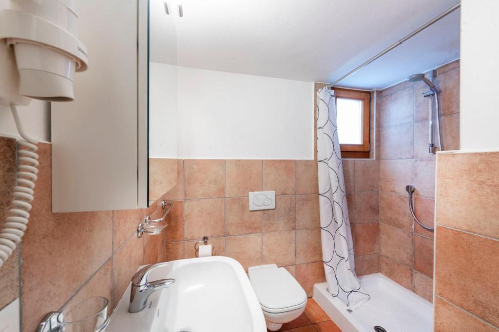 a bathroom with a sink and a toilet and a shower at I Grappoli in Sessa