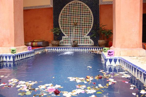 a swimming pool filled with trash in a house at Riad le dromadaire bleu by Weekome in Marrakesh