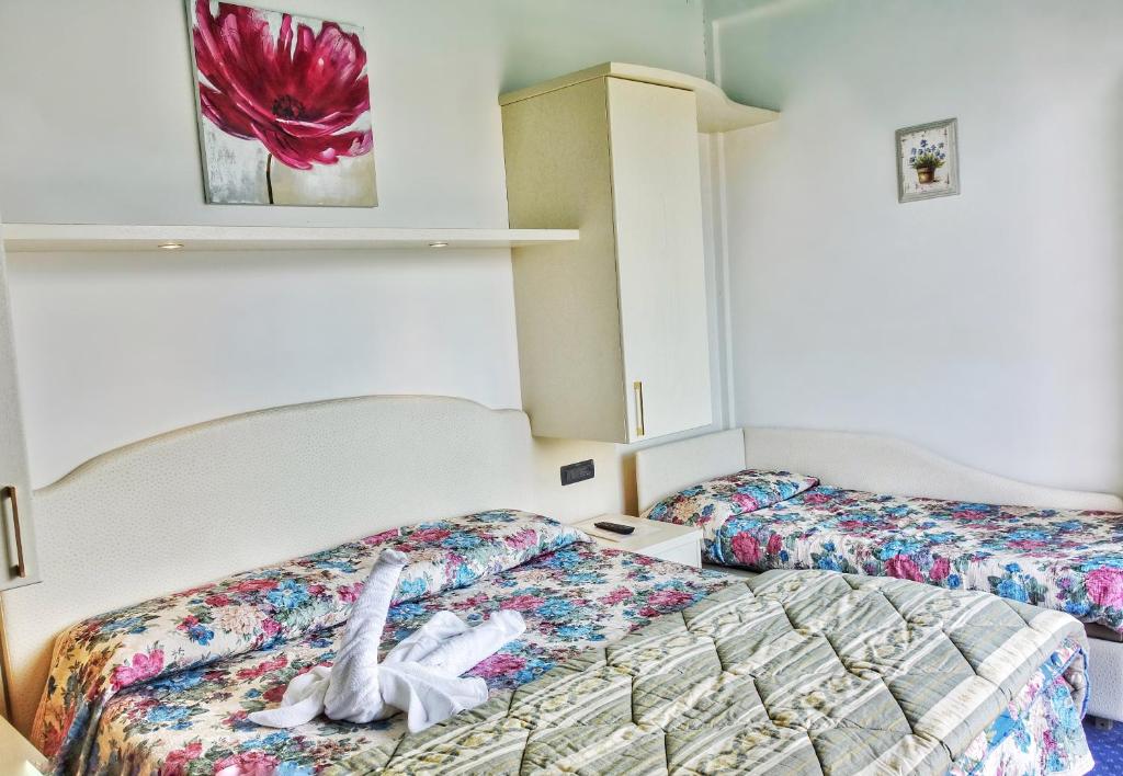 Postel nebo postele na pokoji v ubytování Hotel Tridentum