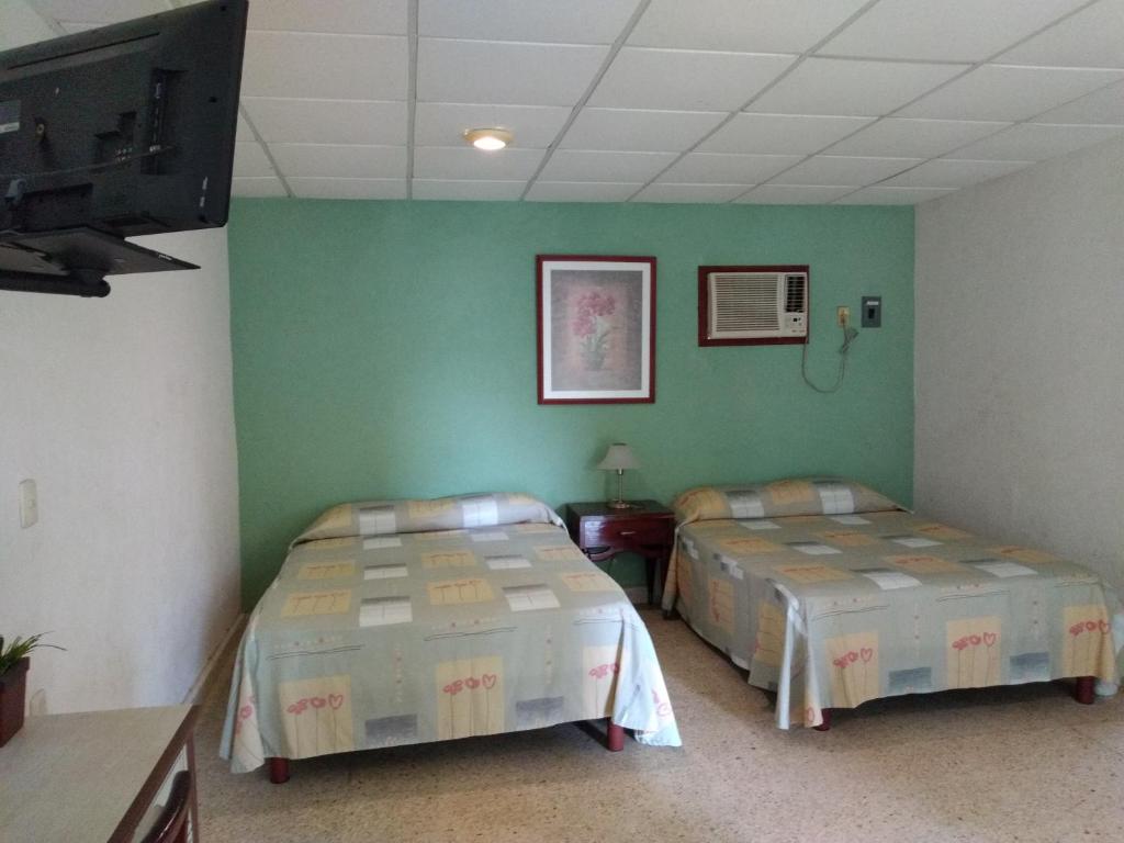 Postel nebo postele na pokoji v ubytování Hotel Playa Azul