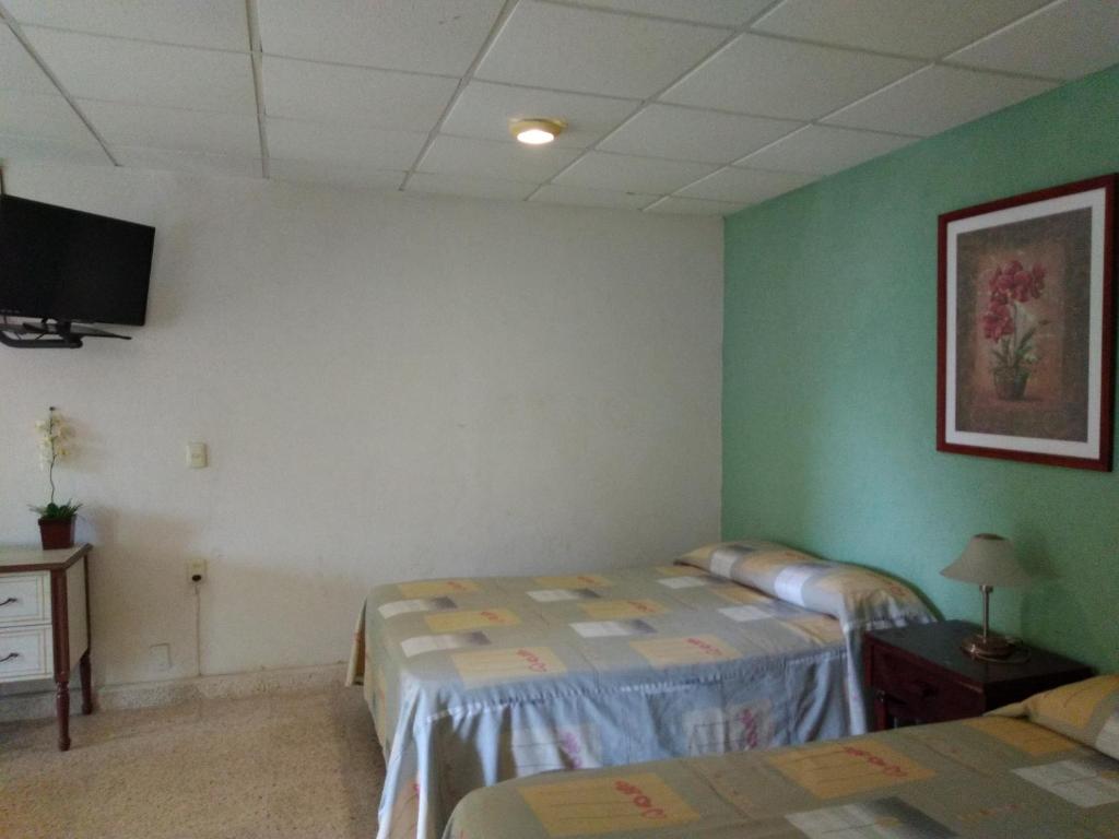 Postel nebo postele na pokoji v ubytování Hotel Playa Azul