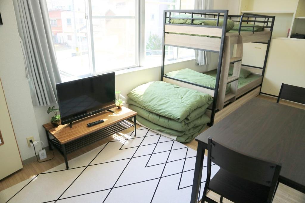 a living room with a tv and a bunk bed at Joynas Ise / Vacation STAY 32706 in Ise