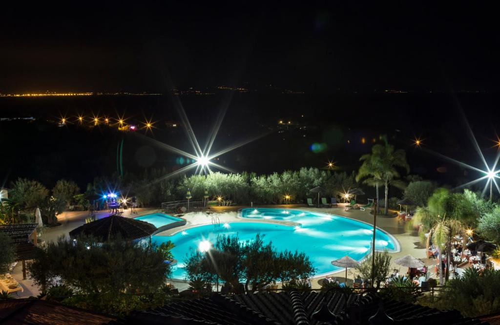 a view of a swimming pool at night at Hotel Santa Chiara in Capo Vaticano
