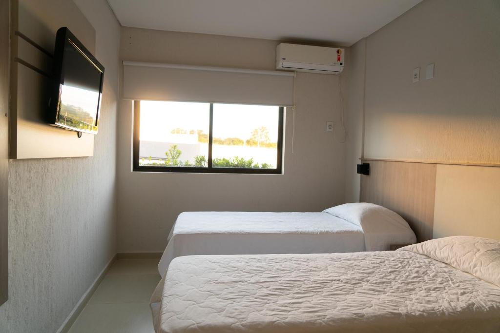 Postel nebo postele na pokoji v ubytování Iguassu Express Hotel