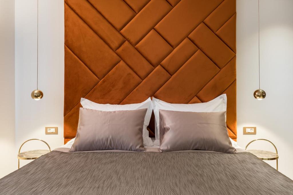 a bed with a large wooden headboard and two pillows at Park Residence in Split