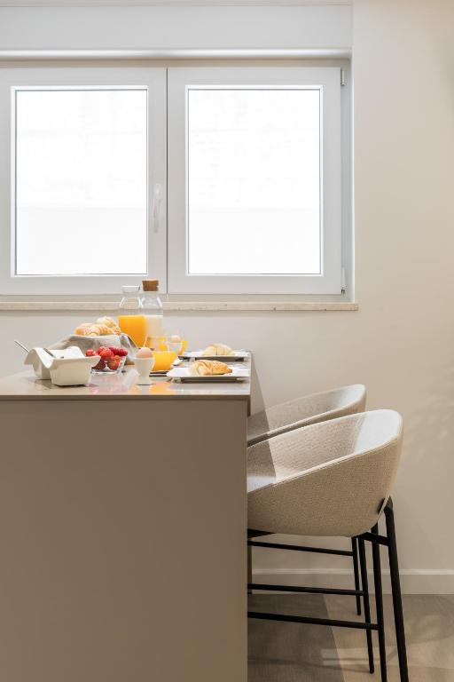 a kitchen with two windows and a table with food on it at Park Residence in Split