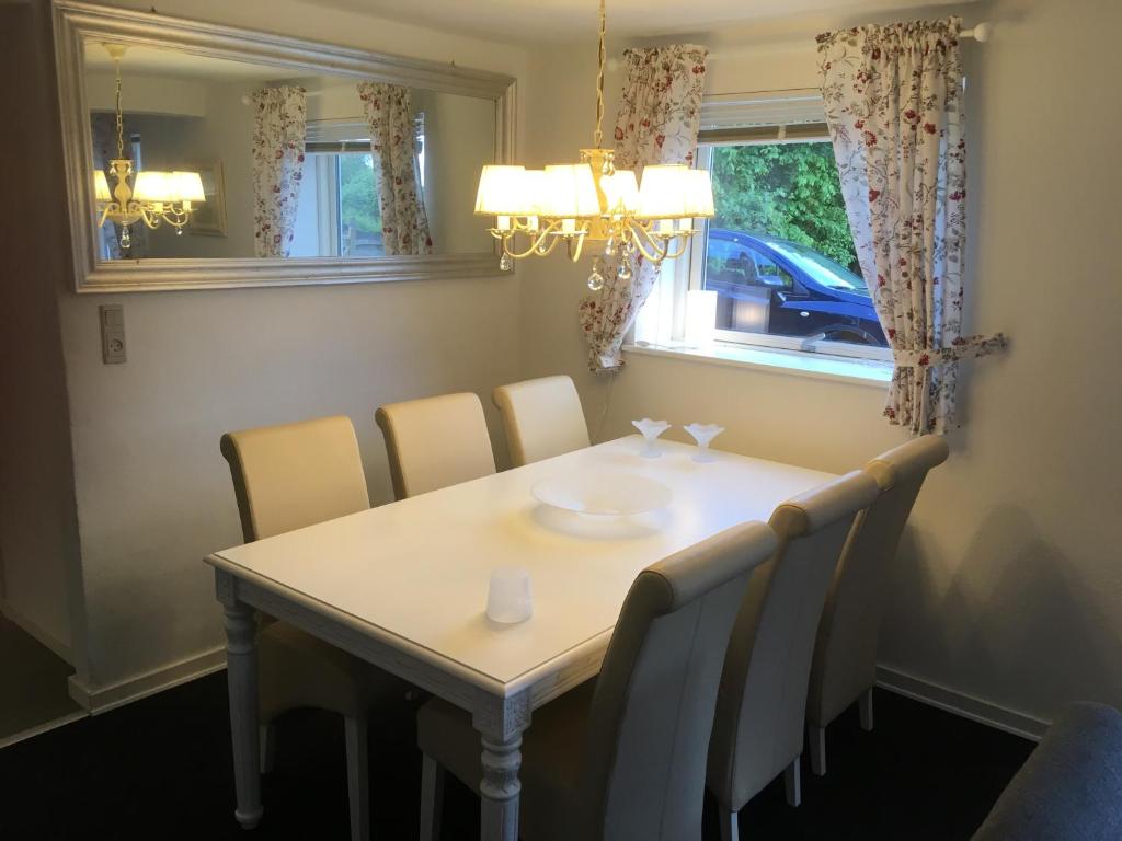 a dining room table with chairs and a chandelier at Give Family Apartment in Give