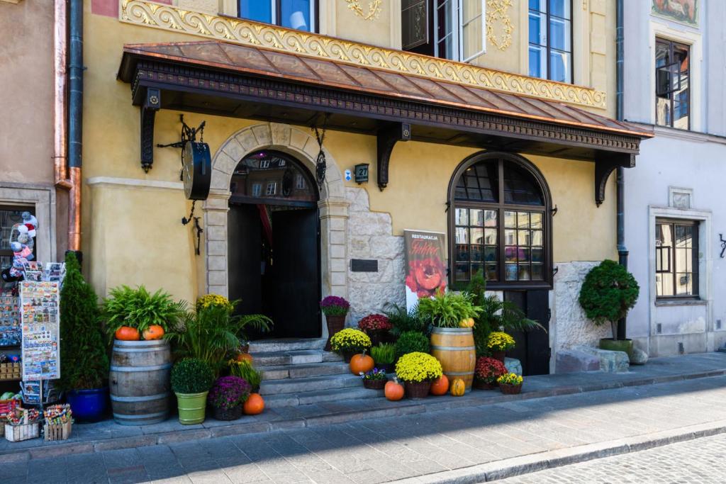 a store with pumpkins on the steps of a building at Warsaw Old Town P&O Serviced Apartments in Warsaw