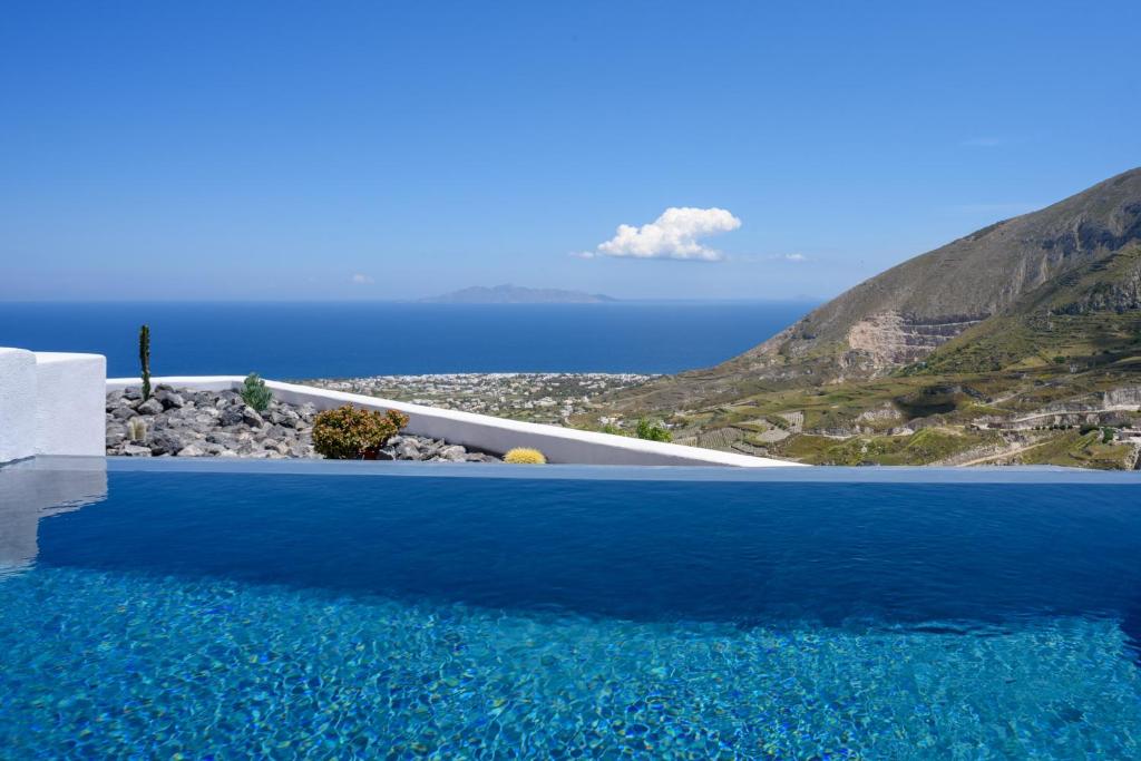 a pool with blue water and a view of the ocean at Delilah Villa by Senses Collection in Pyrgos