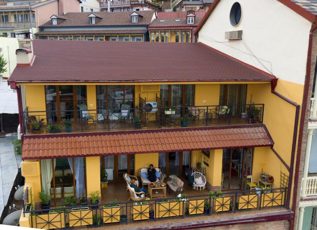 an aerial view of a yellow house with a balcony at 160 degrees in Tbilisi City