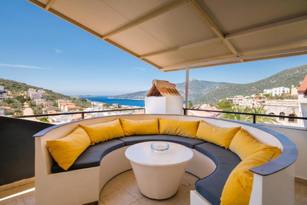 a balcony with a couch and a table at Villa Sea Bella in Kalkan