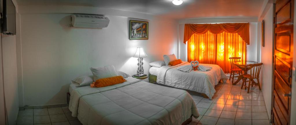 Postel nebo postele na pokoji v ubytování Hotel Andrea