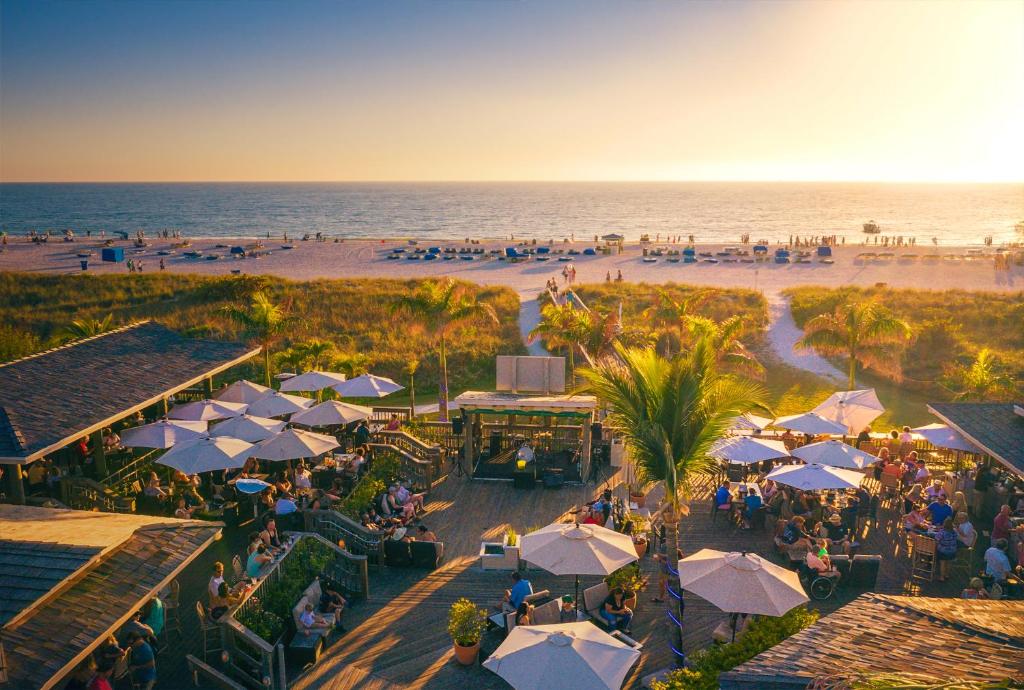 an aerial view of a beach with people and umbrellas at The Beachcomber St. Pete Beach Resort & Hotel in St Pete Beach