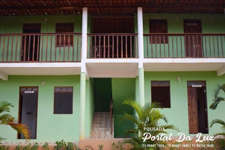 a green and white building with a balcony at POUSADA PORTAL DA LUZ in Entre Rios
