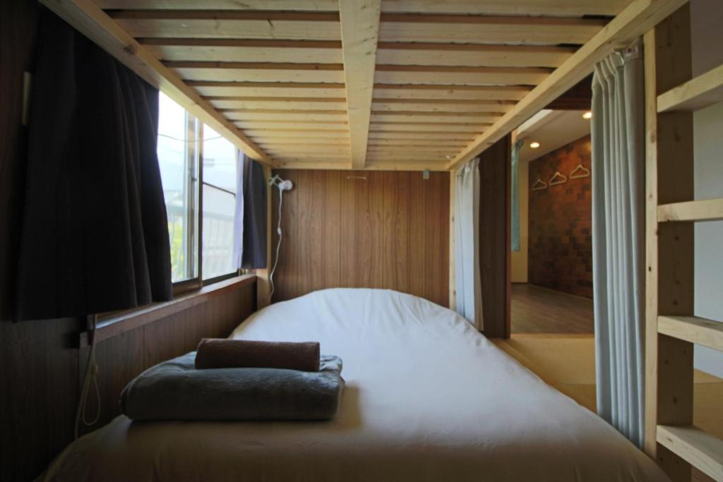 Postel nebo postele na pokoji v ubytování 晴家(HALELUYA) Guest House