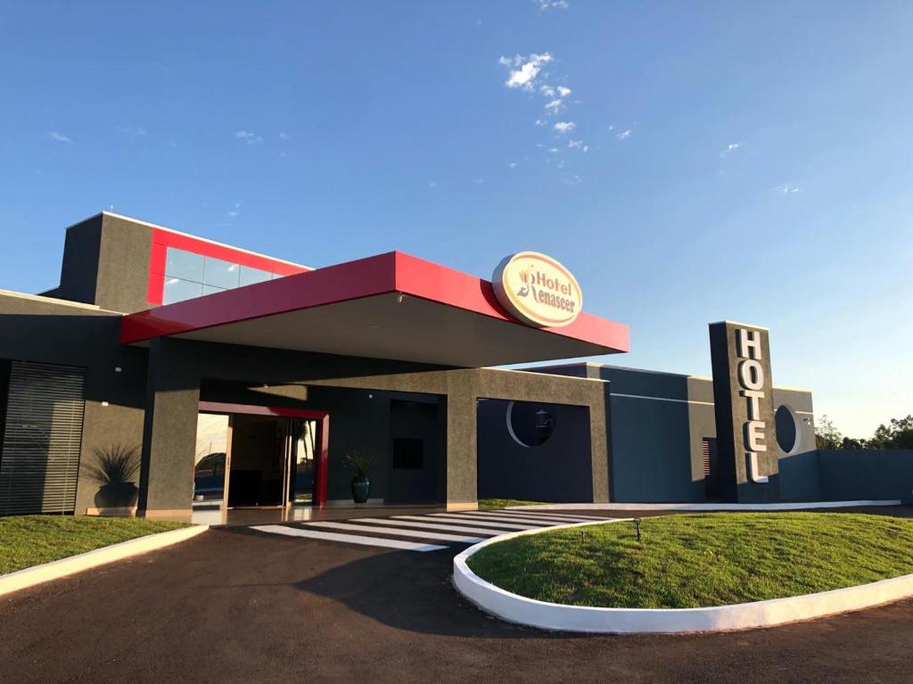 a building with a sign in front of it at Hotel Renascer in Terenos