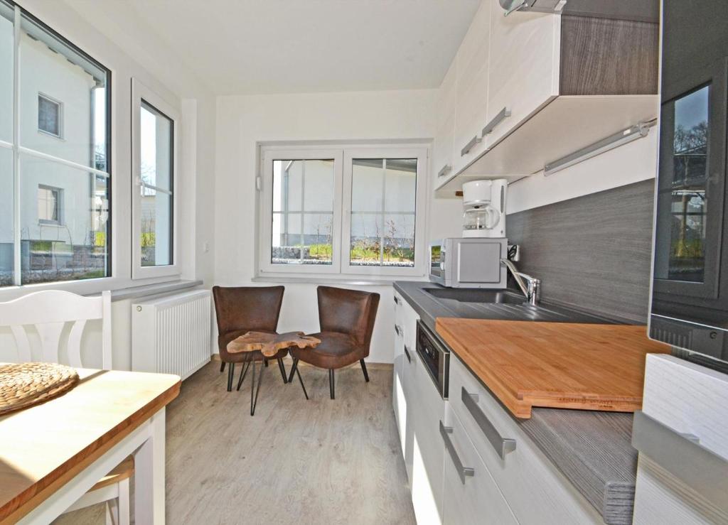 a kitchen with two chairs and a counter top at Villa Doris Bng 8 Hanau in Heringsdorf