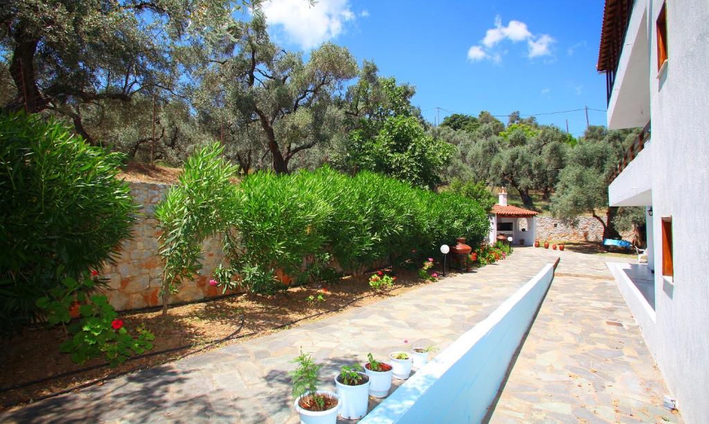 a garden with potted plants sitting on a bench at Villa Maro in Skopelos Town