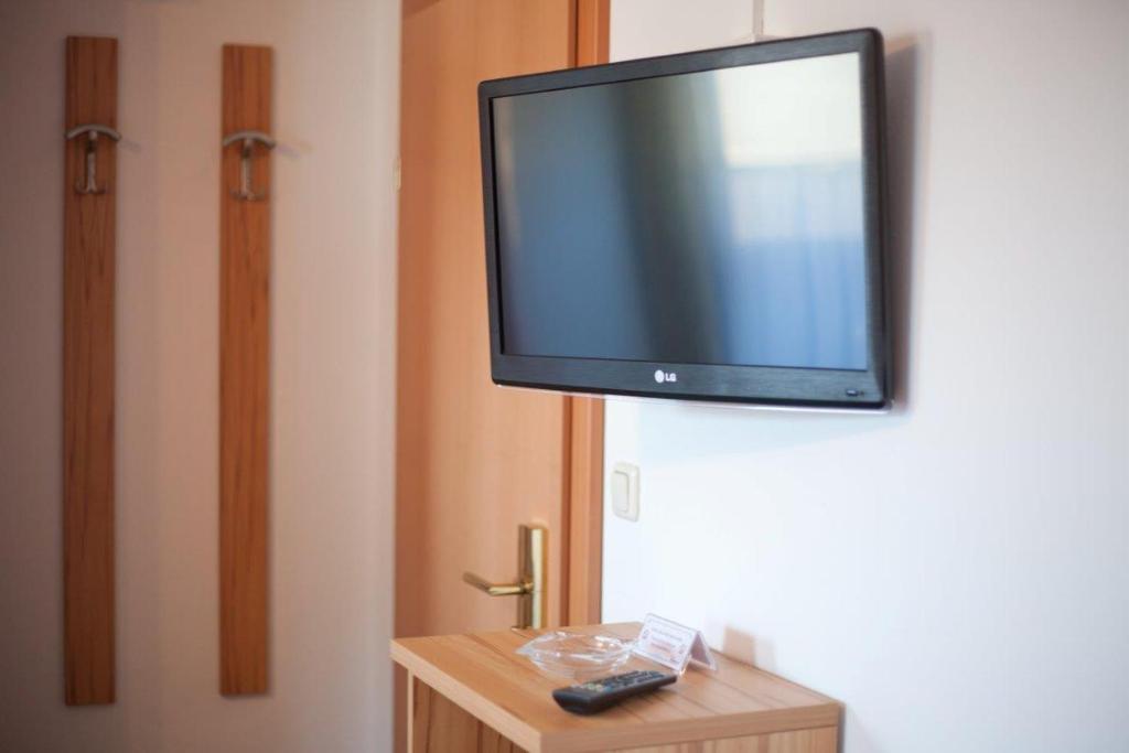 a flat screen tv hanging on a wall at Pension Schierl in Faistenau
