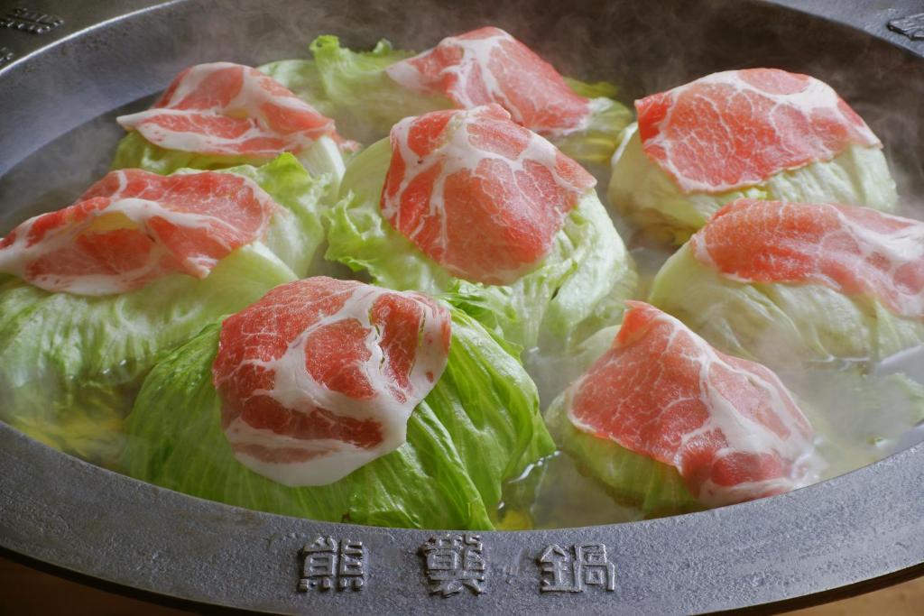 a bowl of food with meat on lettuce at Nanshukan in Kagoshima