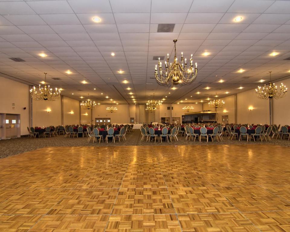 a large banquet hall with a dance floor and chandeliers at Parkview Inn and Conference Center in Allentown