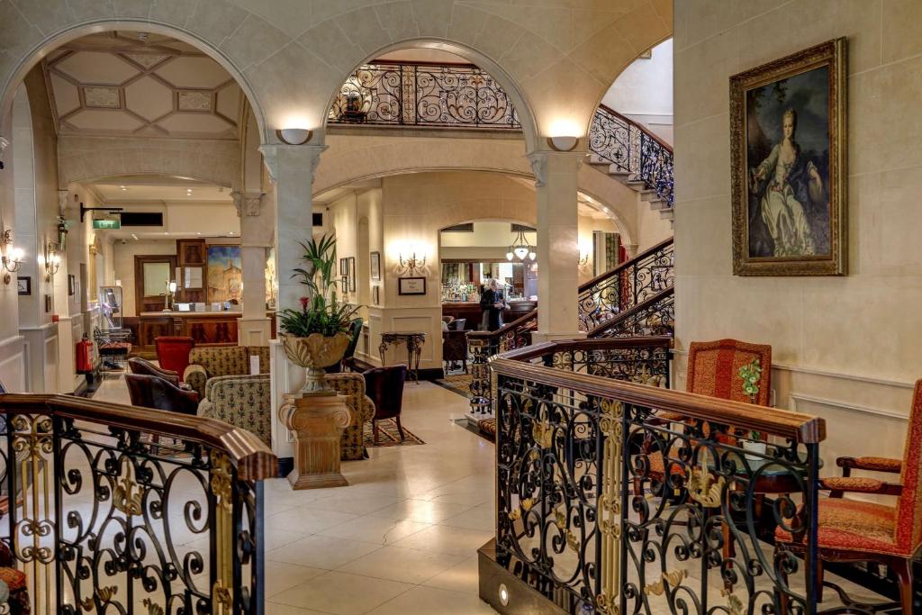 a lobby with a staircase in a building at The Midland Hotel in Bradford