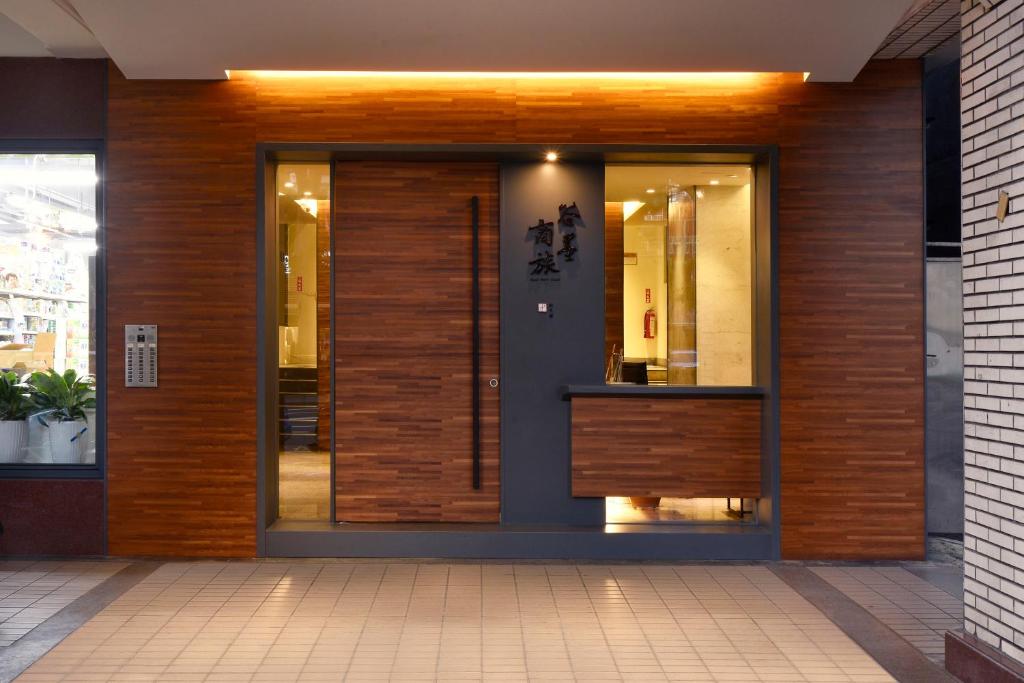 a front door of a building with wood at Goodmore Hotel in Taipei