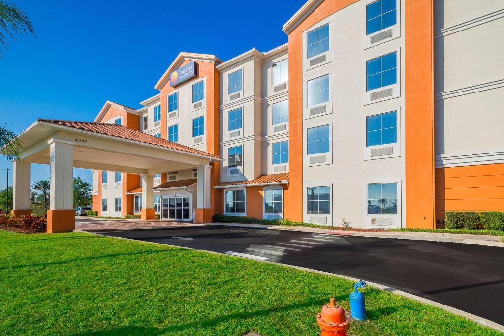 a building with a fire hydrant in front of it at Comfort Inn & Suites Maingate South in Davenport