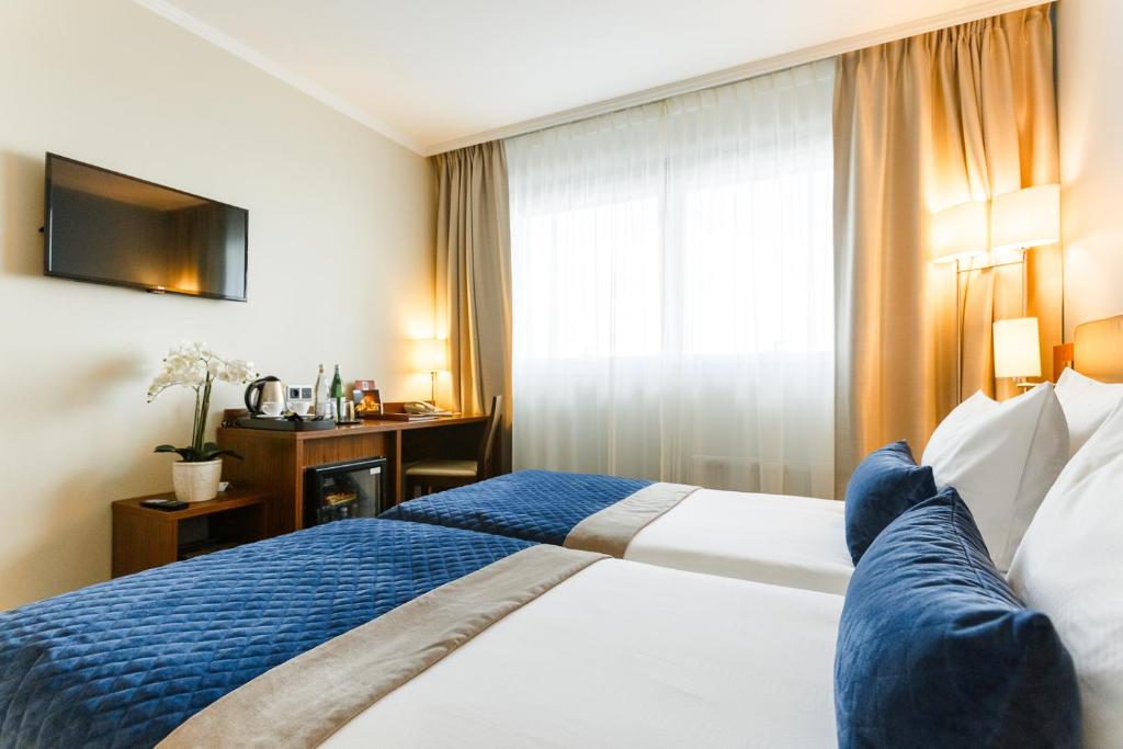 Postel nebo postele na pokoji v ubytování Avalon Hotel & Conferences