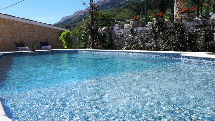 a large swimming pool with two chairs in it at KATY&MLADEN in Baška