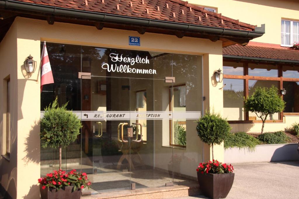 a store with a sign on the front of a building at Hotel Wahlmüller in Sattledt