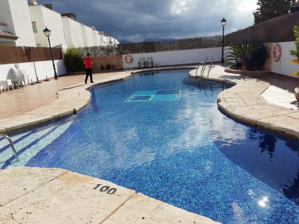 a large swimming pool with blue water in a building at Mirador de Turre in Turre