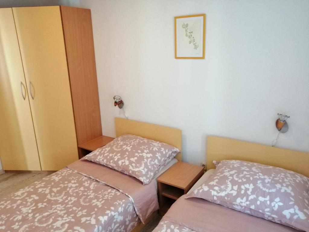 Postel nebo postele na pokoji v ubytování Apartments Ani