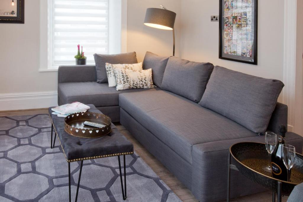 a living room with a blue couch and a table at Blackbird Luxury Apartments Room 3 in Blackpool