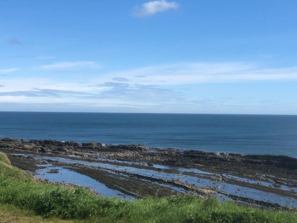 a view of the ocean from the top of a hill at The Old Vicarage in Berwick-Upon-Tweed