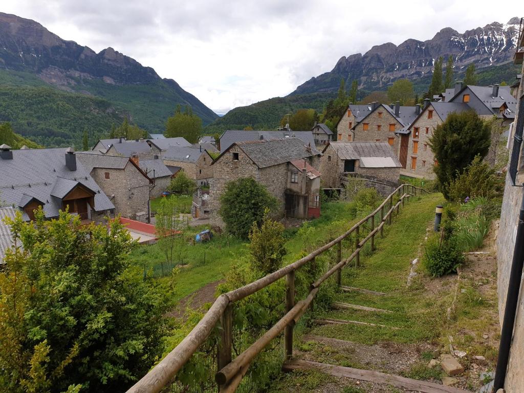 un pueblo en las montañas con una valla de madera en Apartamento Tramacastilla en Tramacastilla de Tena