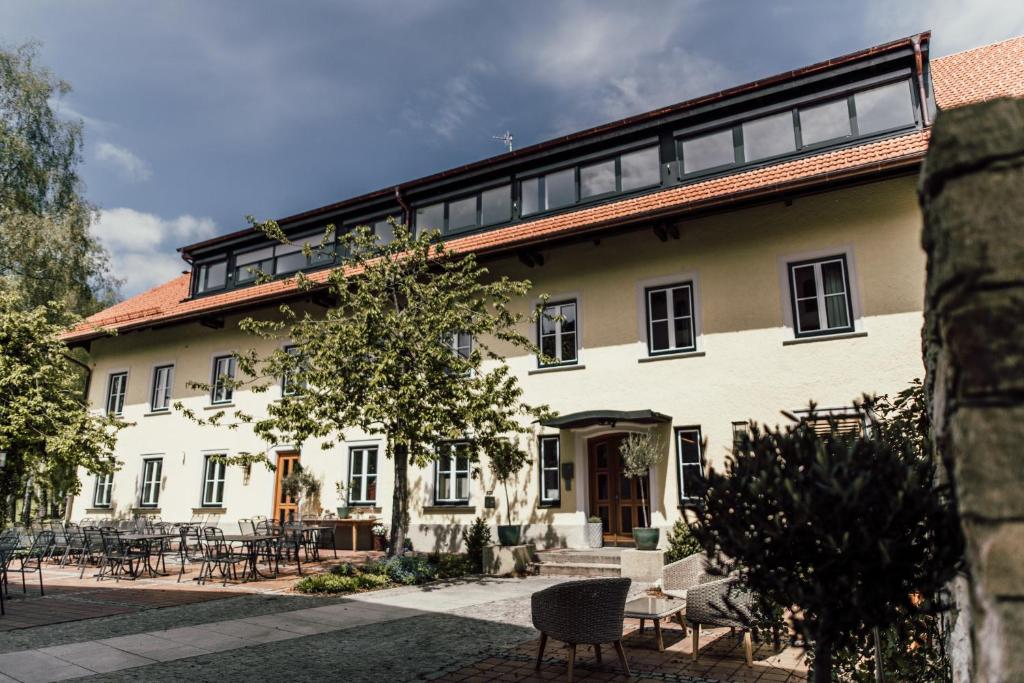 a large white building with a lot of windows at Angermühle Landgasthof in Altenmarkt an der Alz