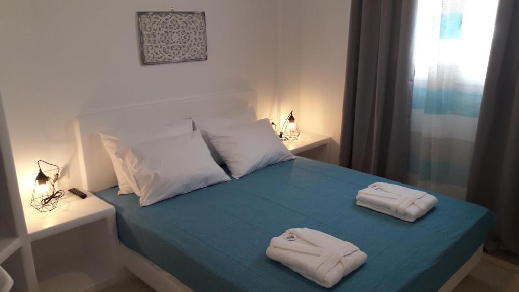 a bedroom with two towels on a bed at Maistrali Prive in Karterados