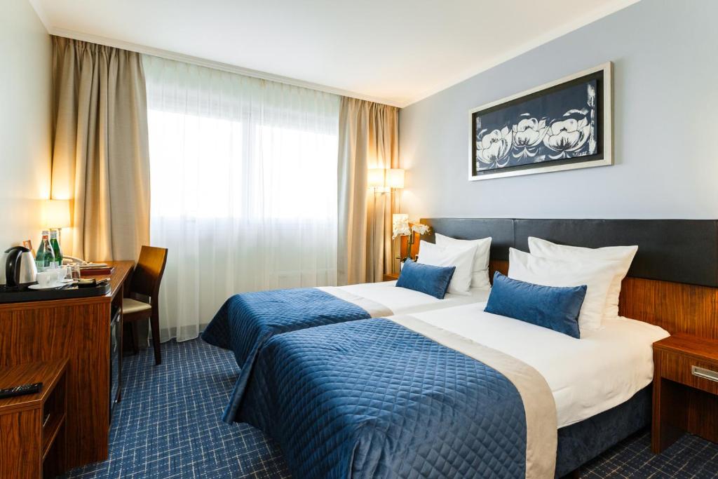 Postel nebo postele na pokoji v ubytování Avalon Hotel & Conferences