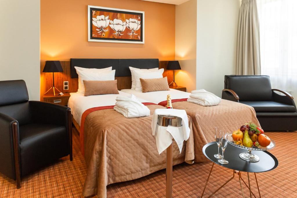 Postel nebo postele na pokoji v ubytování Avalon Hotel & Conferences