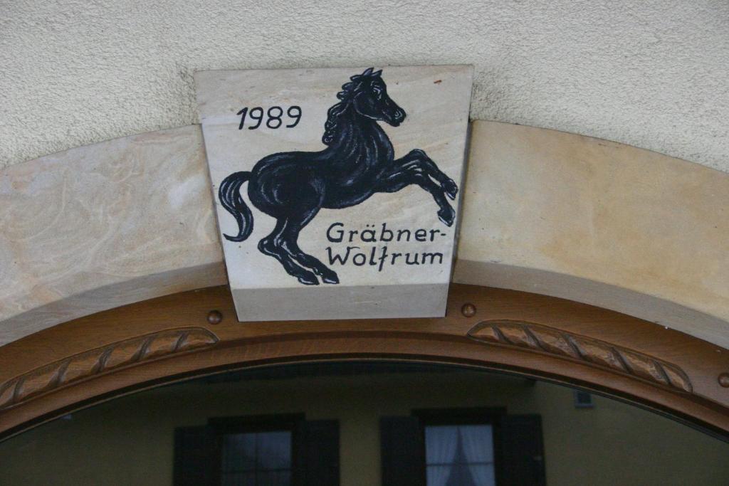 a sign on top of a building with a horse on it at Gasthof Hotel Schwarzes Roß in Bad Berneck im Fichtelgebirge