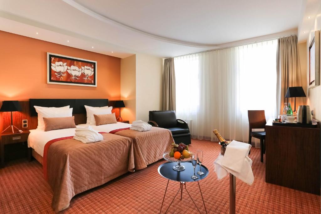 Postel nebo postele na pokoji v ubytování Avalon Hotel & Conferences