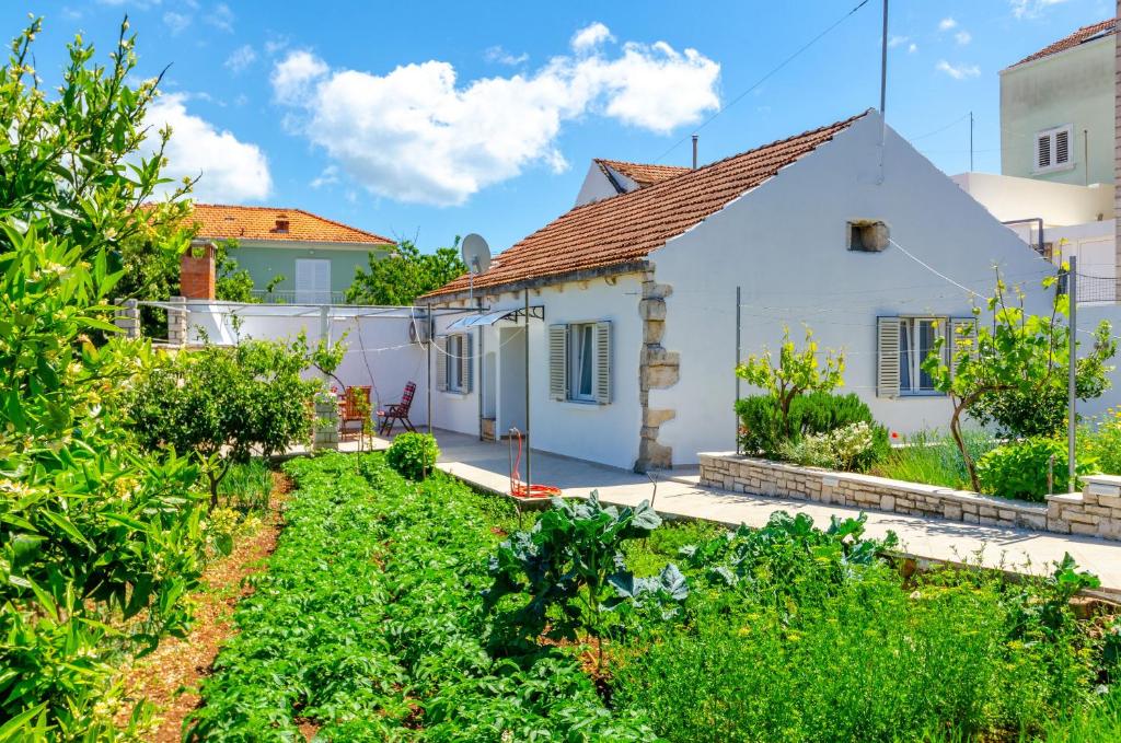 a white house with a garden in front of it at House Lara in Vela Luka