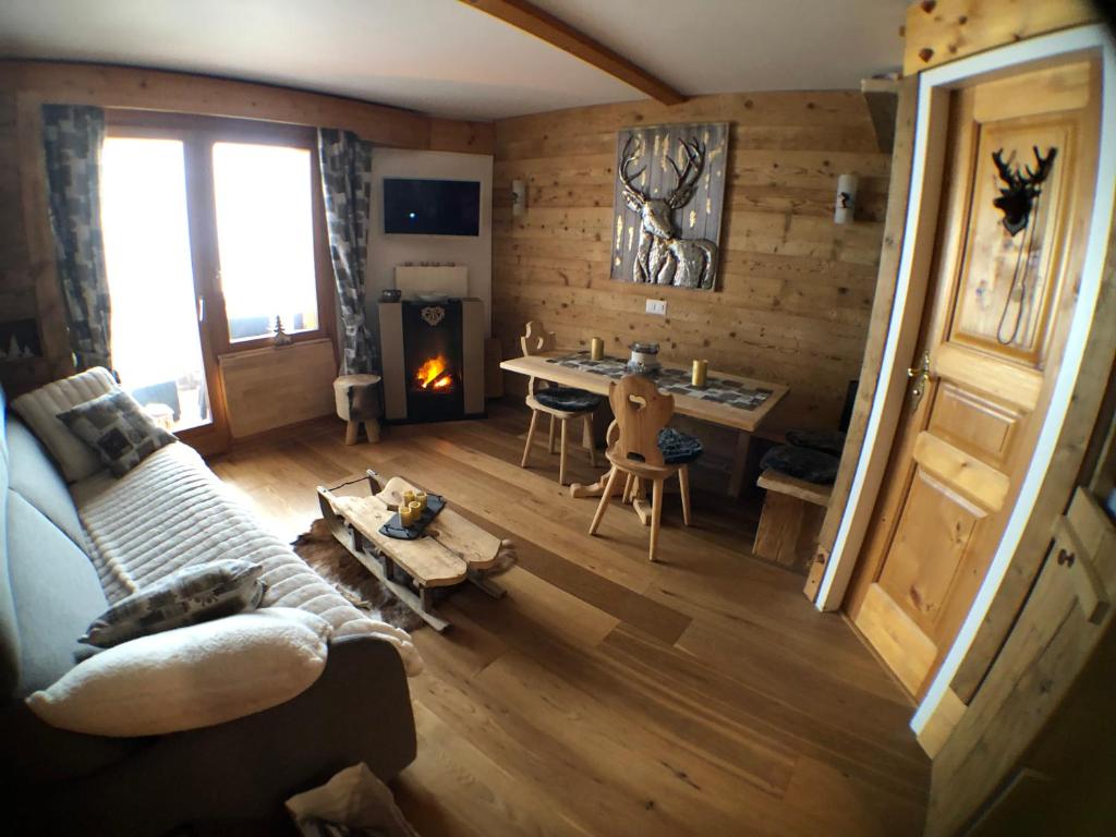 a living room with a couch and a table at Le Bristol - Villars Bristol Apartments in Villars-sur-Ollon