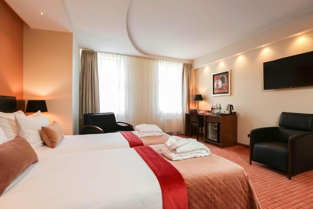 Postel nebo postele na pokoji v ubytování Avalon Hotel & Conferences