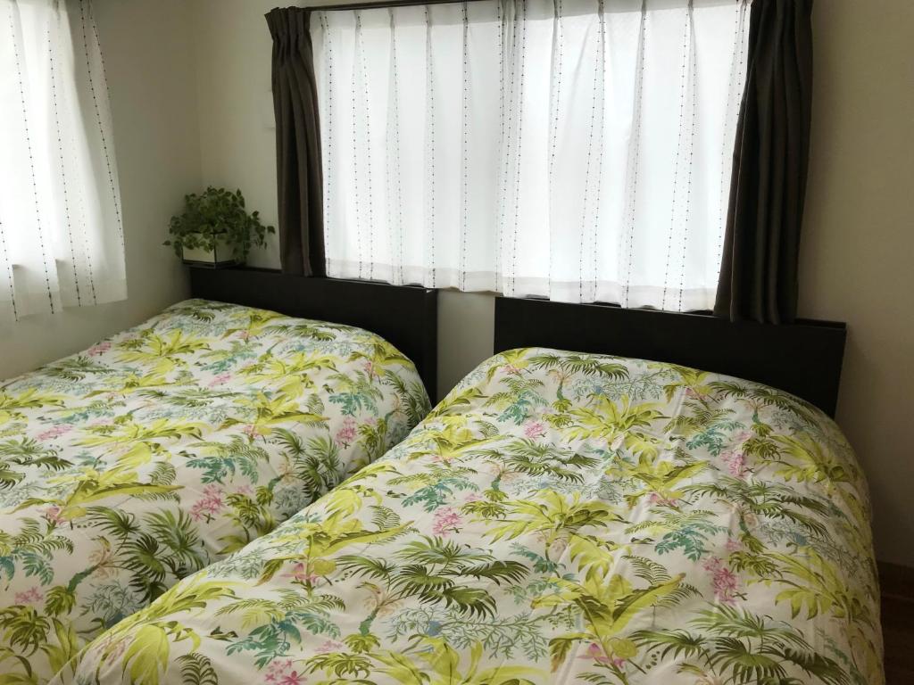 Postel nebo postele na pokoji v ubytování LAKA.M -ラカ ドット エム-